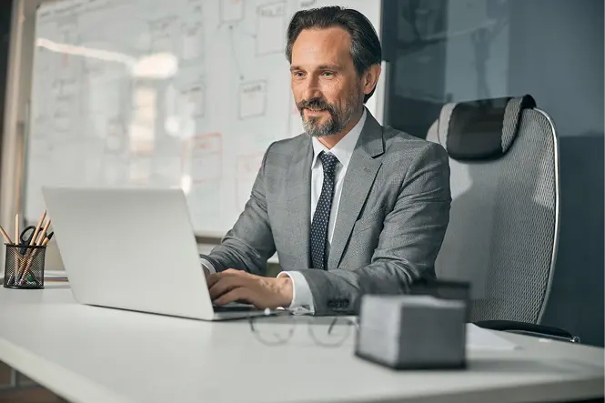 European Businessman Wearing Grey Coat Sitting